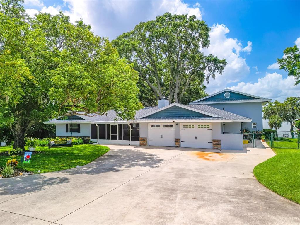 250 Brigham Road Northwest Winter Haven, FL 33881 - Photo 1 of 65 a view of a house with a yard and sitting area