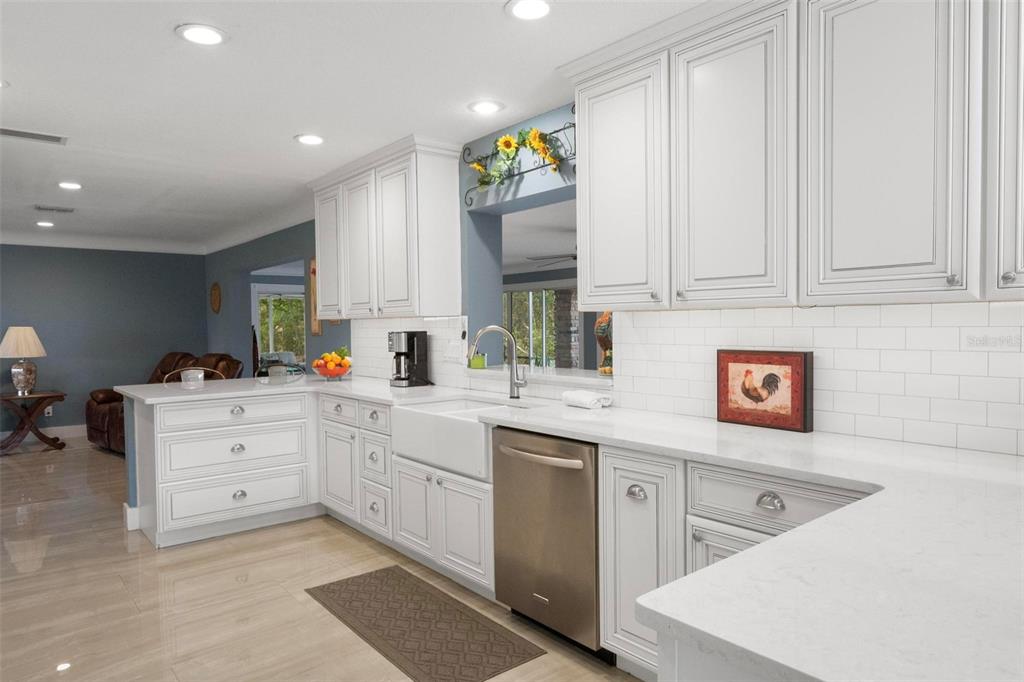 250 Brigham Road Northwest Winter Haven, FL 33881 - Photo 17 of 65 a kitchen filled with white cabinets and white appliances
