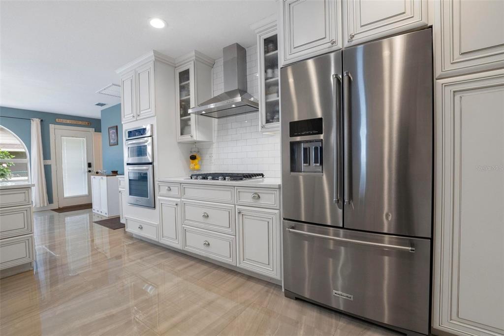 250 Brigham Road Northwest Winter Haven, FL 33881 - Photo 18 of 65 a kitchen with stainless steel appliances a refrigerator stove and cabinets