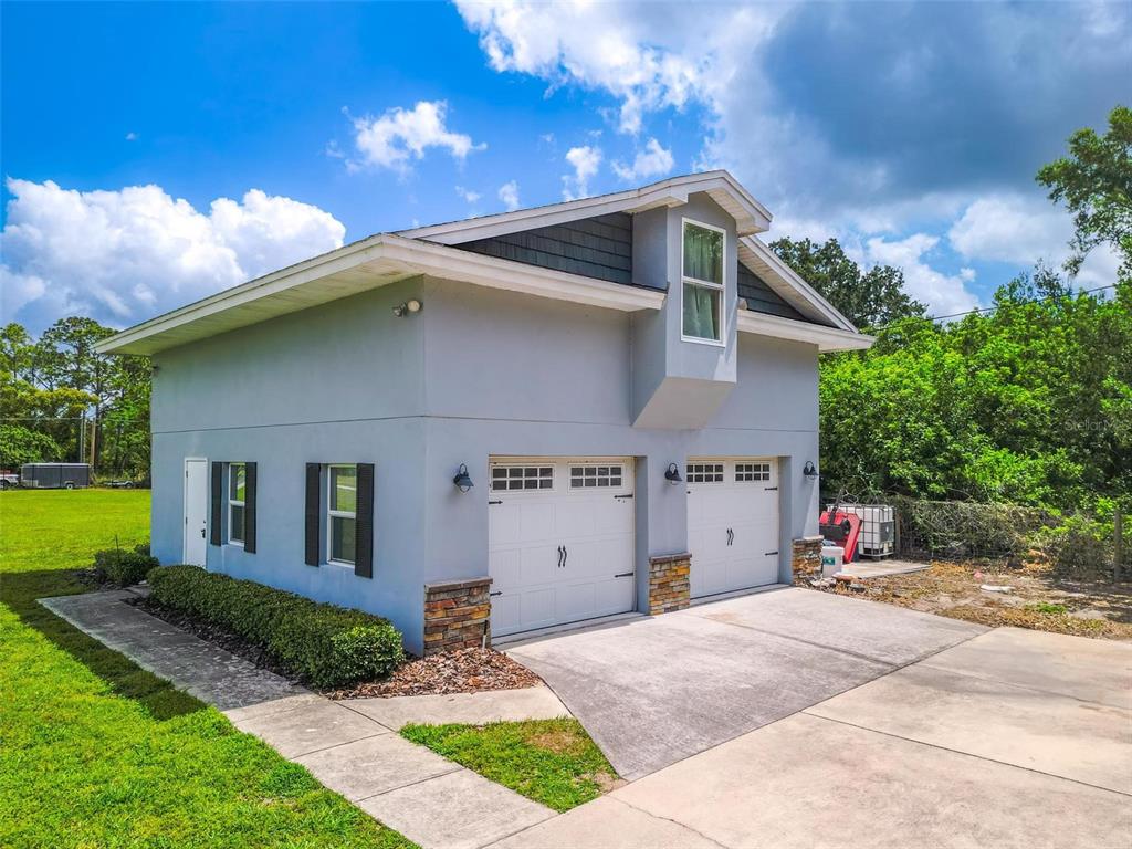 250 Brigham Road Northwest Winter Haven, FL 33881 - Photo 2 of 65 a front view of a house with garden