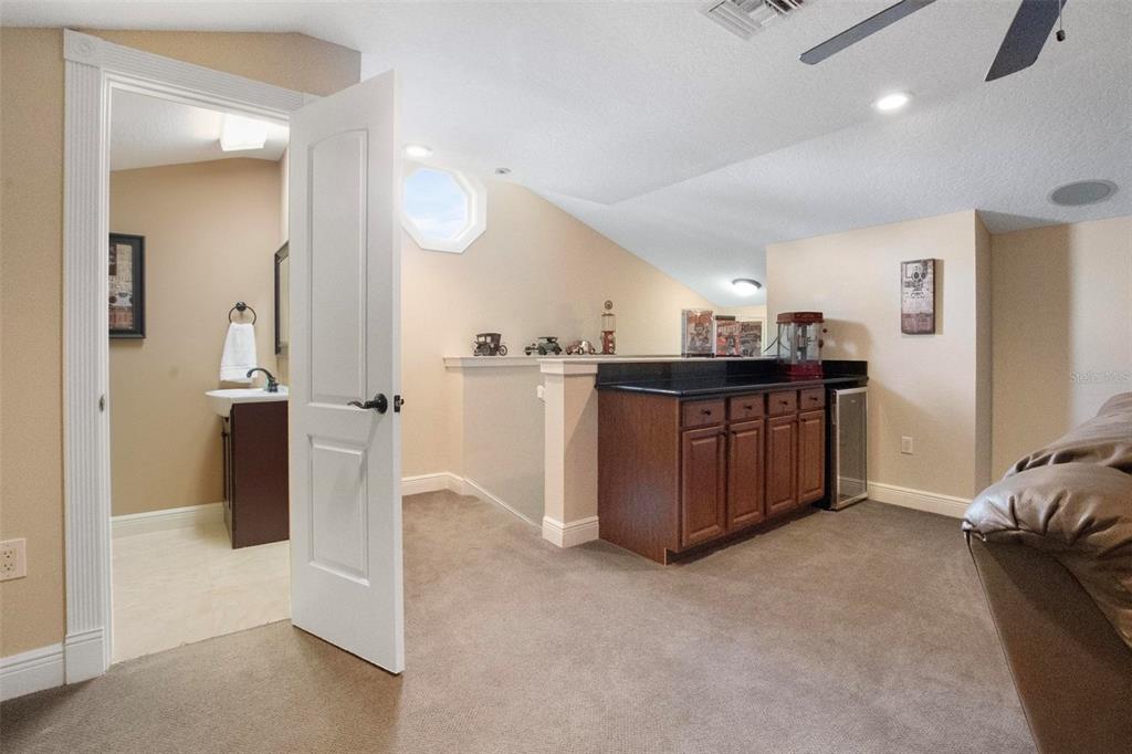 250 Brigham Road Northwest Winter Haven, FL 33881 - Photo 28 of 65 a kitchen with stainless steel appliances kitchen island granite countertop a refrigerator and a sink