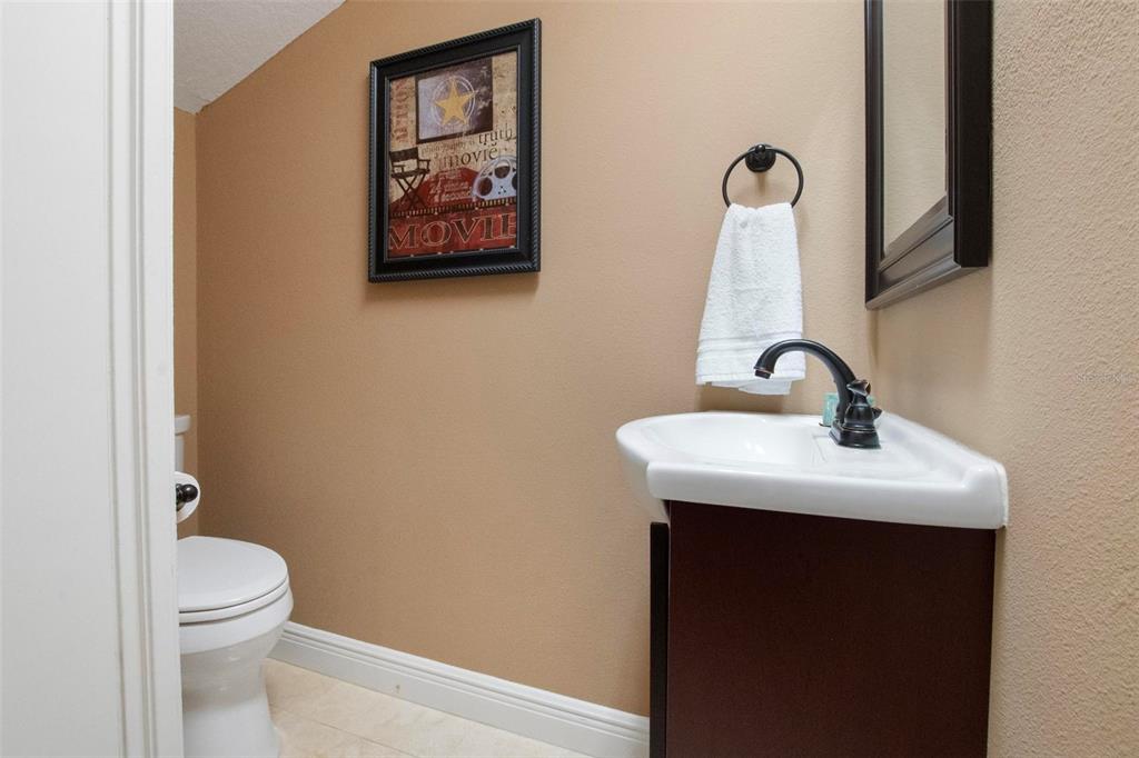 250 Brigham Road Northwest Winter Haven, FL 33881 - Photo 29 of 65 a bathroom with a toilet sink and mirror