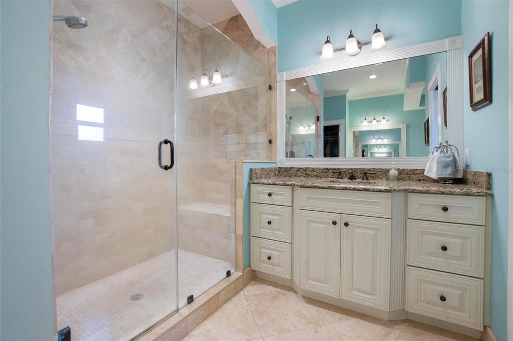 250 Brigham Road Northwest Winter Haven, FL 33881 - Photo 35 of 65 a bathroom with a granite countertop sink mirror and shower