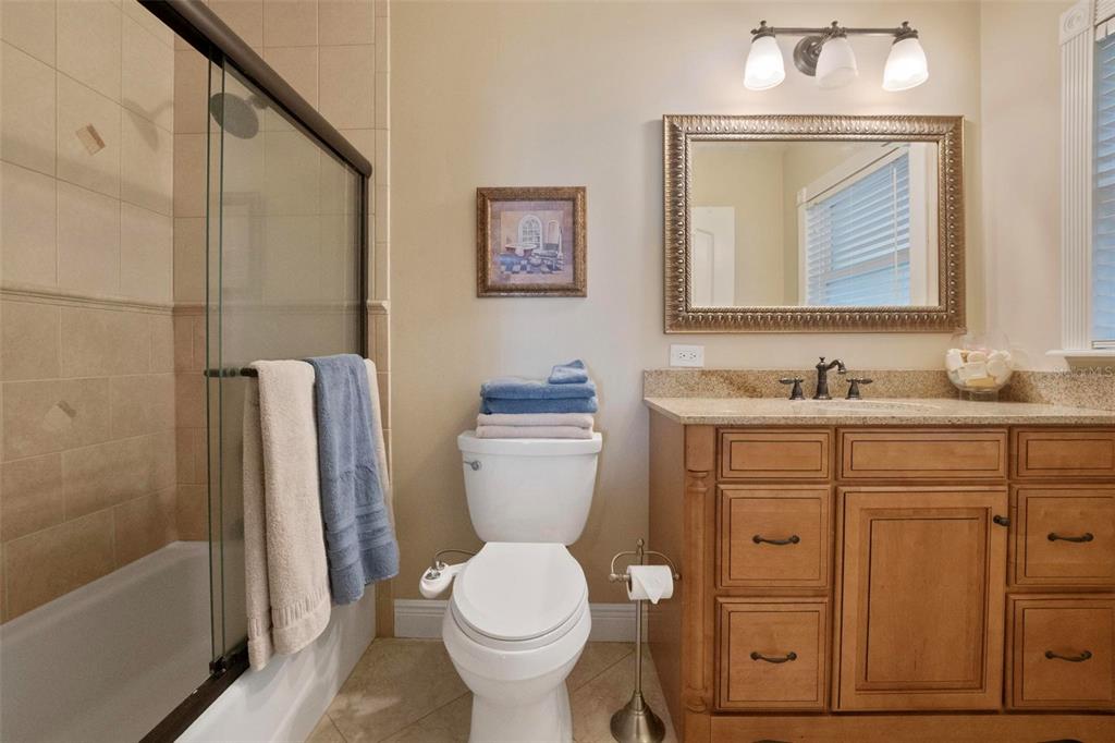 250 Brigham Road Northwest Winter Haven, FL 33881 - Photo 39 of 65 a bathroom with a granite countertop toilet sink and mirror