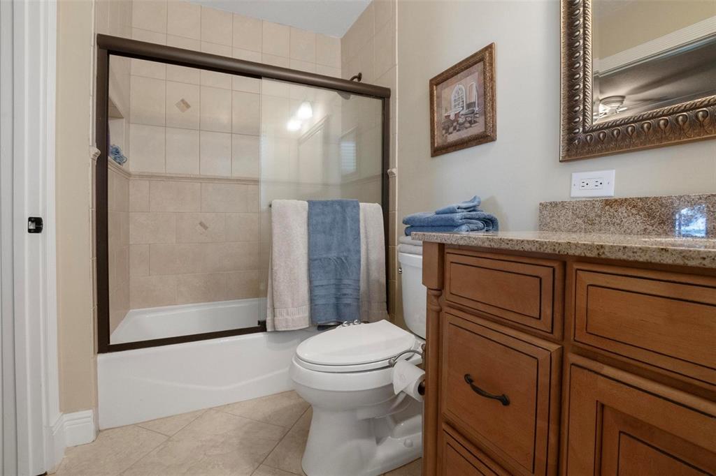 250 Brigham Road Northwest Winter Haven, FL 33881 - Photo 40 of 65 a bathroom with a granite countertop sink toilet and shower