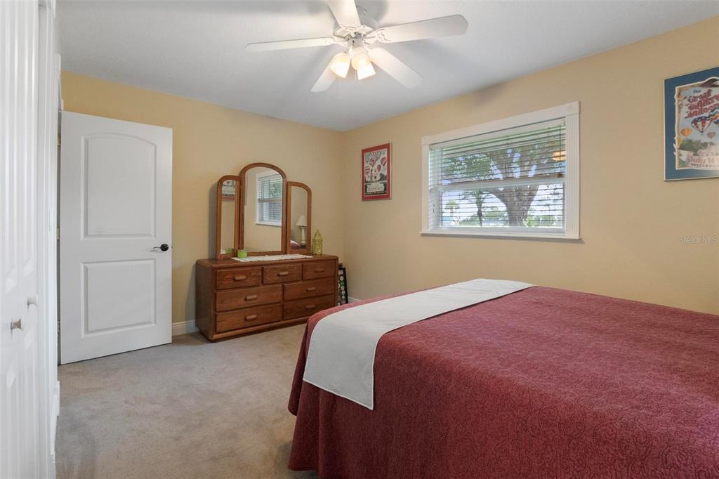 250 Brigham Road Northwest Winter Haven, FL 33881 - Photo 42 of 65 a bedroom with a bed and a chandelier