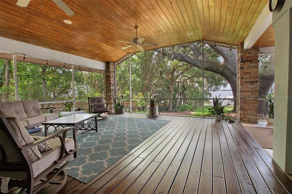 250 Brigham Road Northwest Winter Haven, FL 33881 - Photo 44 of 65 a view of a patio with table and chairs under an umbrella with wooden floor