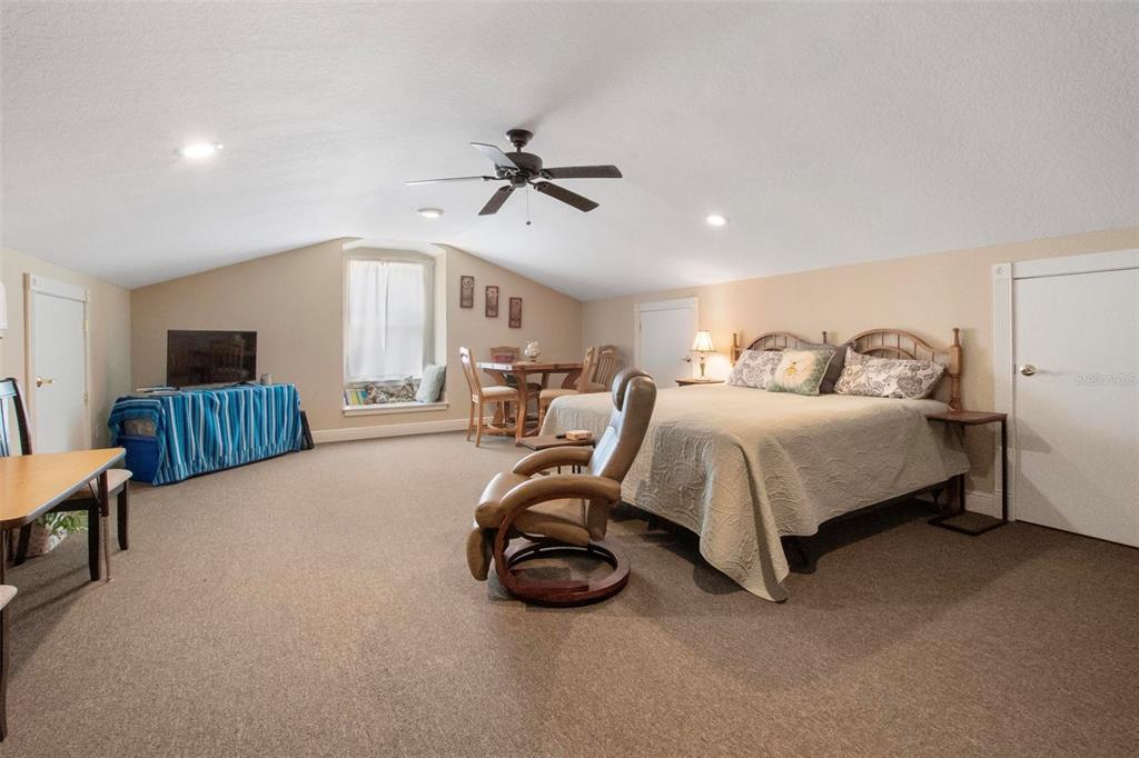 250 Brigham Road Northwest Winter Haven, FL 33881 - Photo 53 of 65 a spacious bedroom with a bed and a ceiling fan