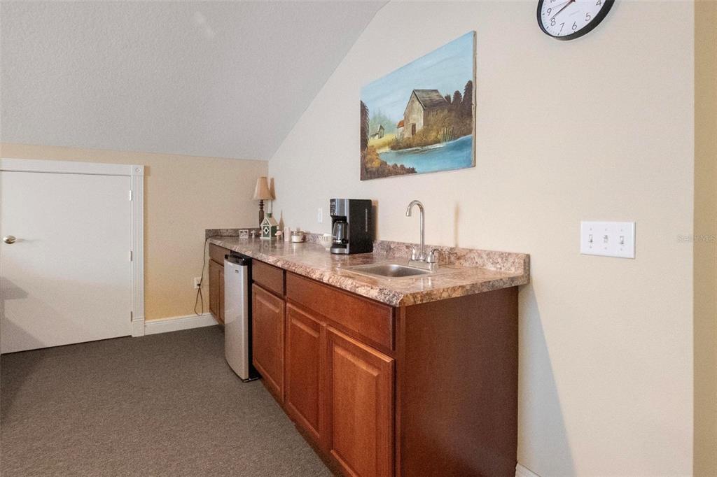 250 Brigham Road Northwest Winter Haven, FL 33881 - Photo 57 of 65 a kitchen with a sink and a refrigerator