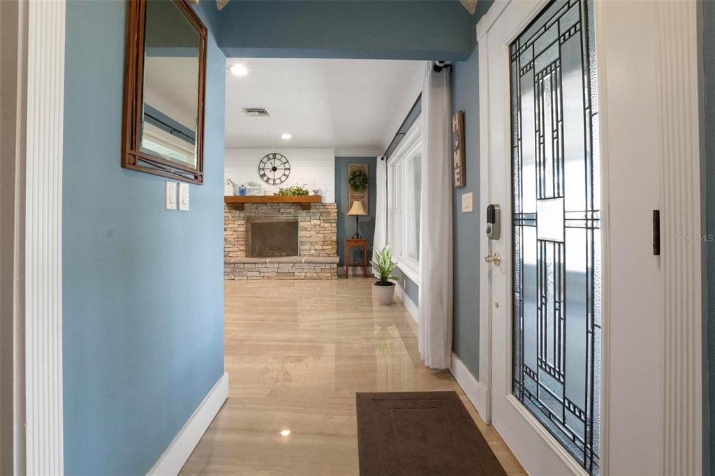 250 Brigham Road Northwest Winter Haven, FL 33881 - Photo 6 of 65 a view of a hallway with a livingroom and a dinning room with windows