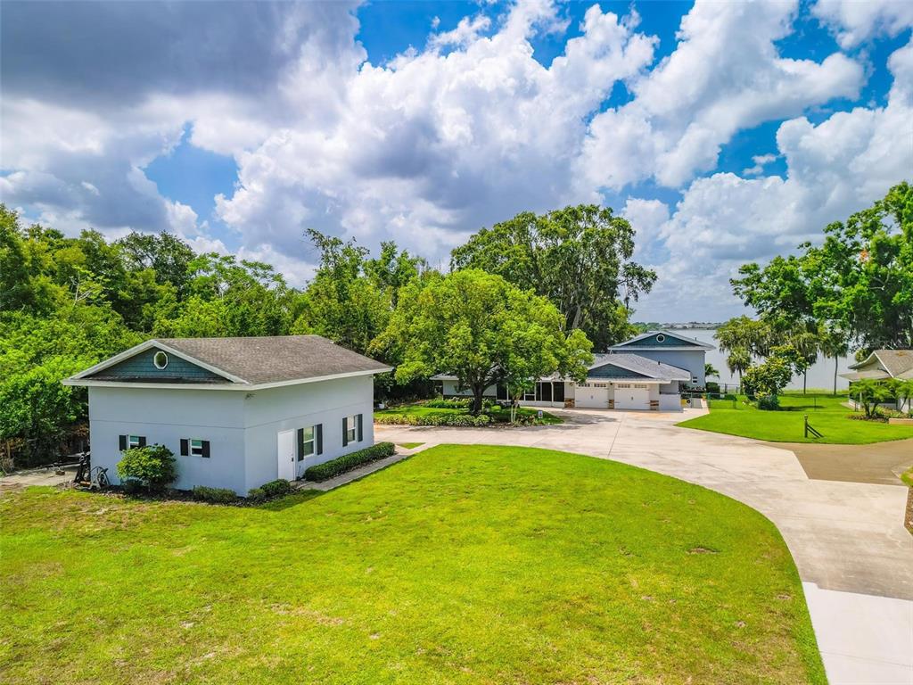 250 Brigham Road Northwest Winter Haven, FL 33881 - Photo 63 of 65 a aerial view of a house with swimming pool and a yard