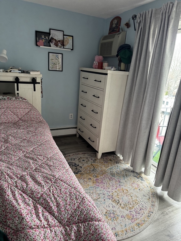 358 Broadway, Unit 13 Lynn, MA 01904 - Photo 18 of 26 a view of a bedroom with baby bed and workspace
