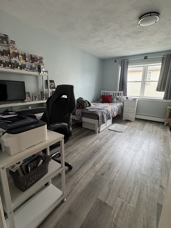 358 Broadway, Unit 13 Lynn, MA 01904 - Photo 19 of 26 a living room with furniture and a flat screen tv
