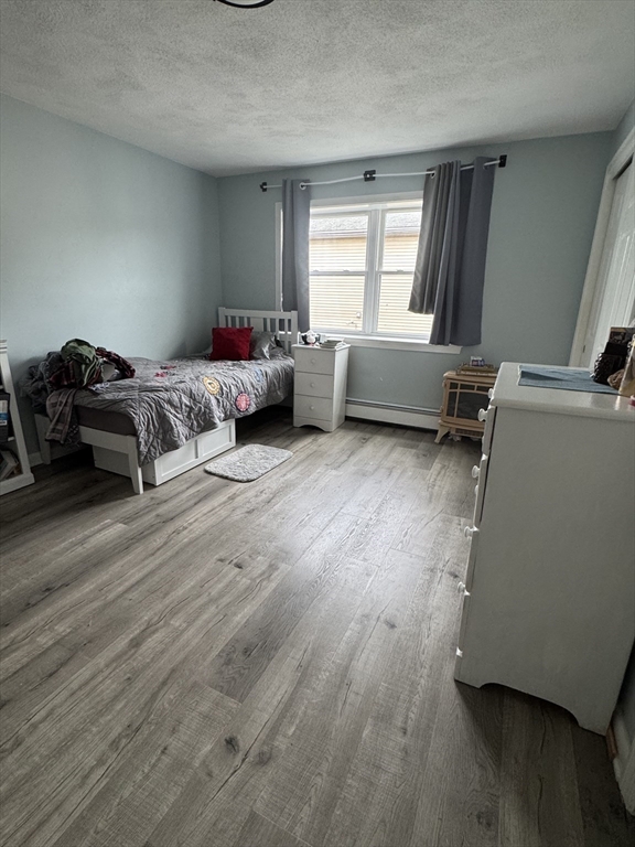 358 Broadway, Unit 13 Lynn, MA 01904 - Photo 21 of 26 a bedroom with furniture and a window