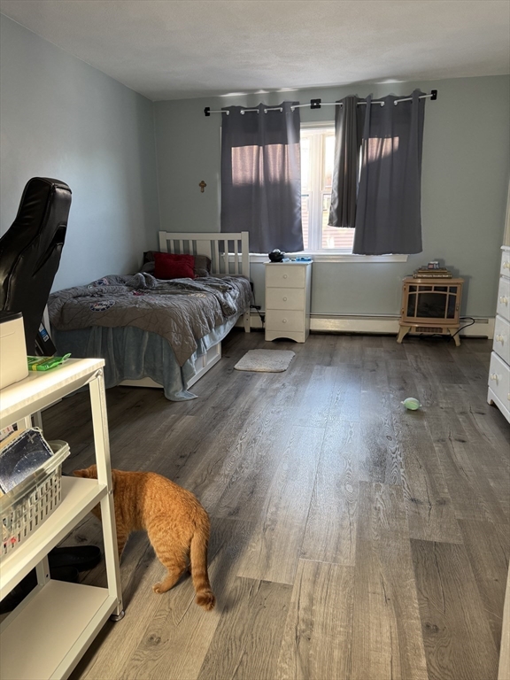 358 Broadway, Unit 13 Lynn, MA 01904 - Photo 22 of 26 a bedroom with a bed and a window