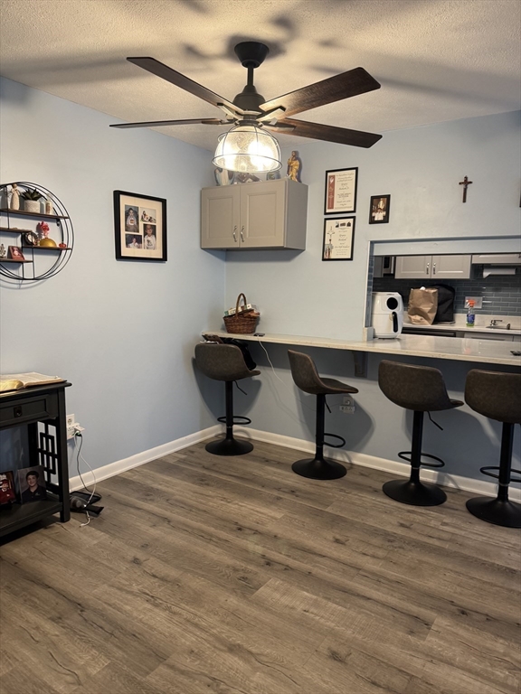 358 Broadway, Unit 13 Lynn, MA 01904 - Photo 5 of 26 a view of a workspace with furniture and a ceiling fan