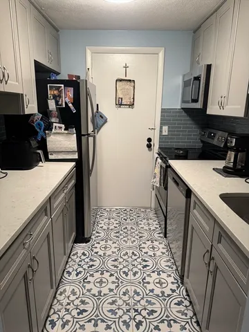 a kitchen with a sink and a refrigerator