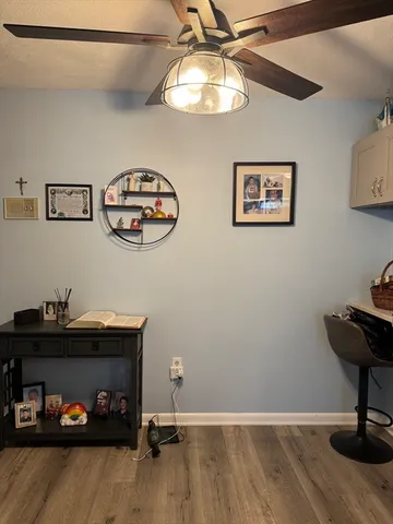 a view of a workspace with furniture and lamp on dresser