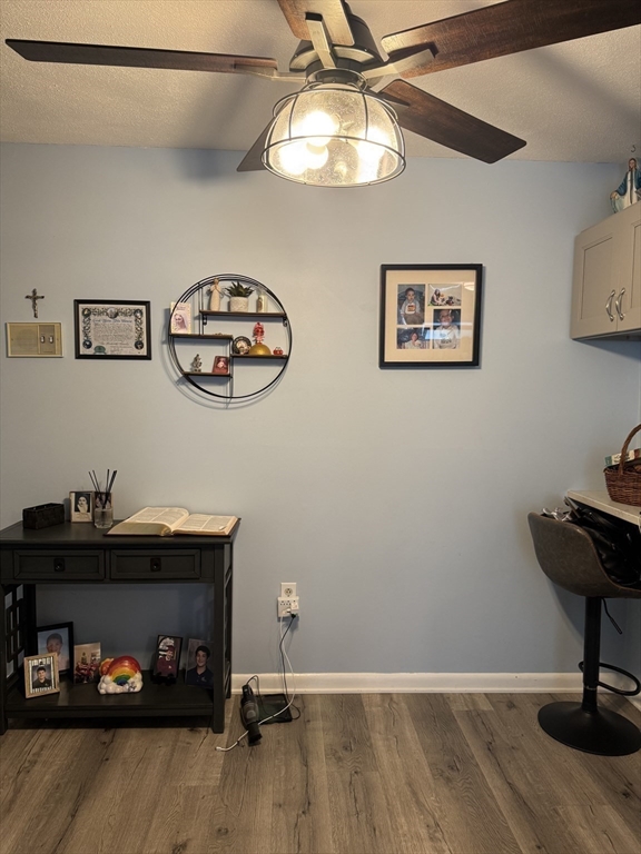 358 Broadway, Unit 13 Lynn, MA 01904 - Photo 10 of 26 a view of a workspace with furniture and lamp on dresser