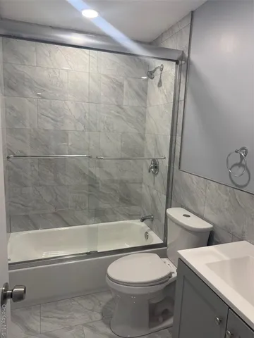 a bathroom with a toilet a sink and bathtub