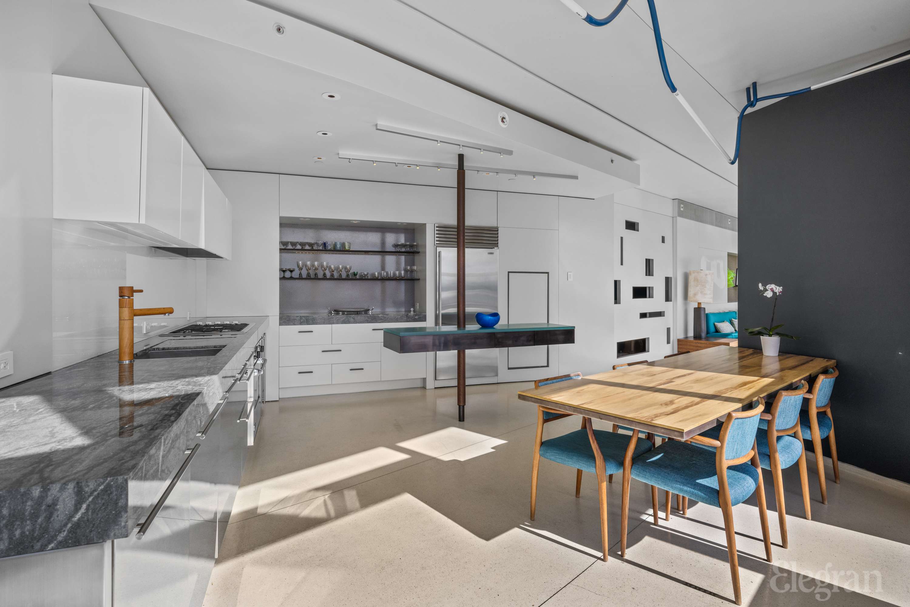 100 11th Avenue, Unit 11B Manhattan, NY 10011 - Photo 3 of 19 a kitchen that has a table and chairs in it