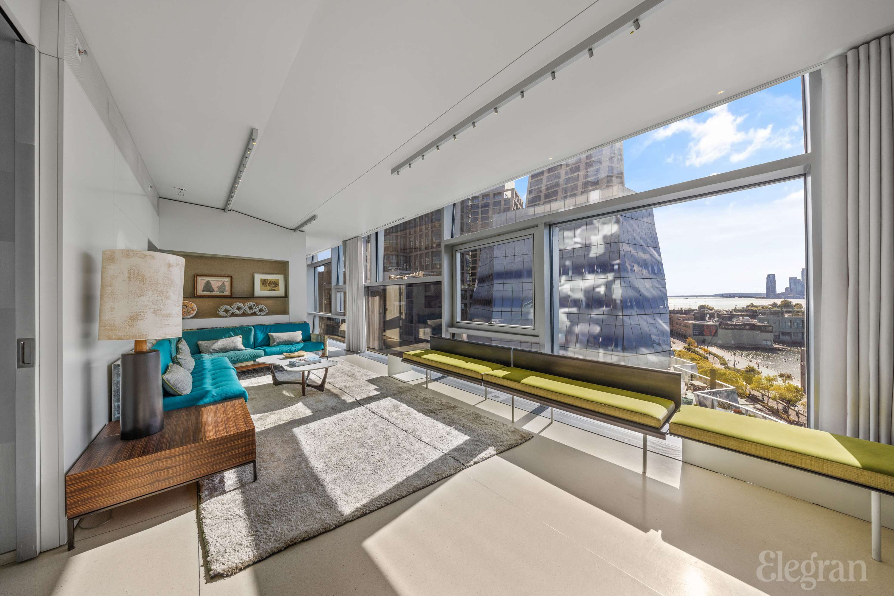 100 11th Avenue, Unit 11B Manhattan, NY 10011 - Photo 5 of 19 a living room with furniture and a table