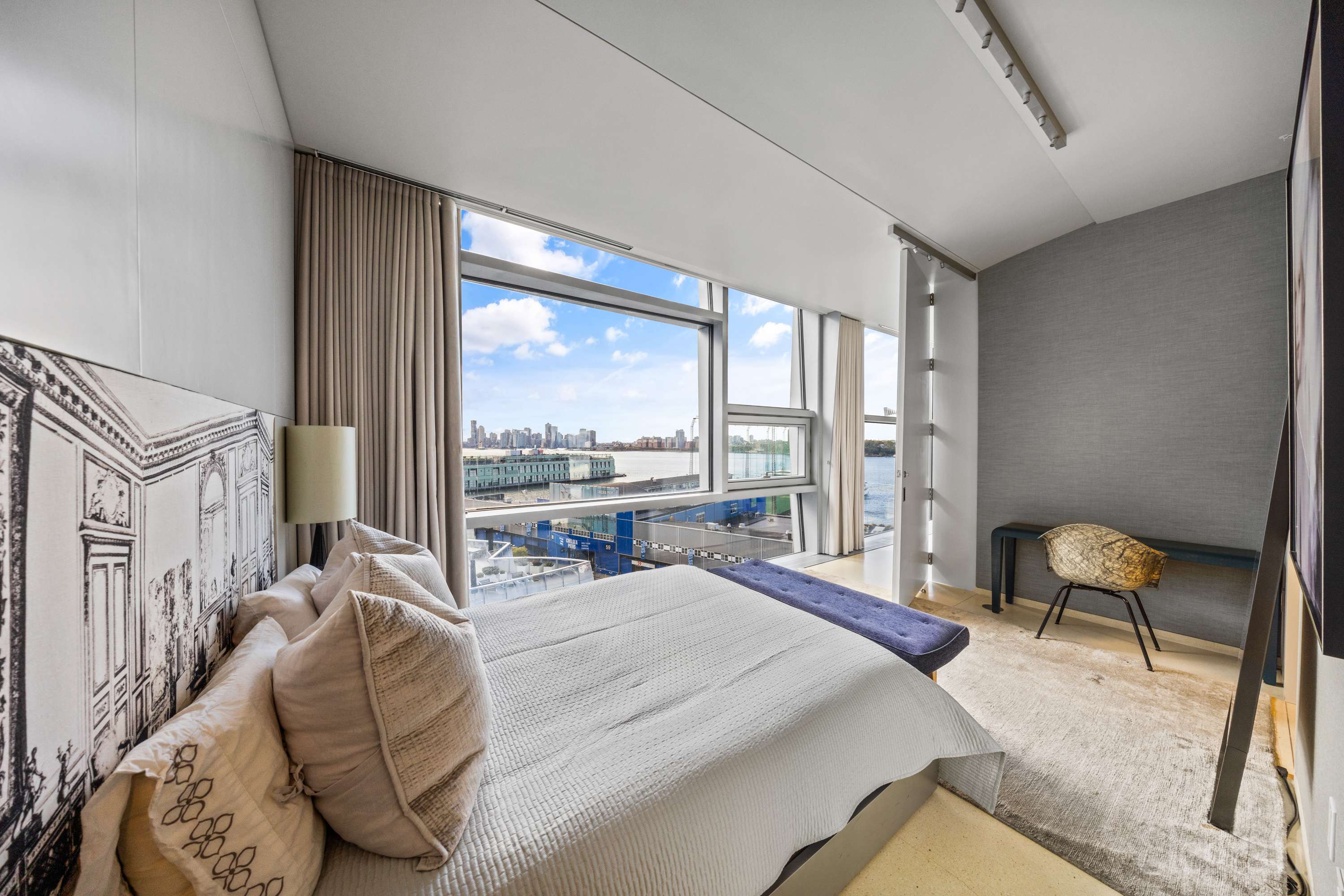 100 11th Avenue, Unit 11B Manhattan, NY 10011 - Photo 8 of 19 a bedroom with a bed and a large window with chair