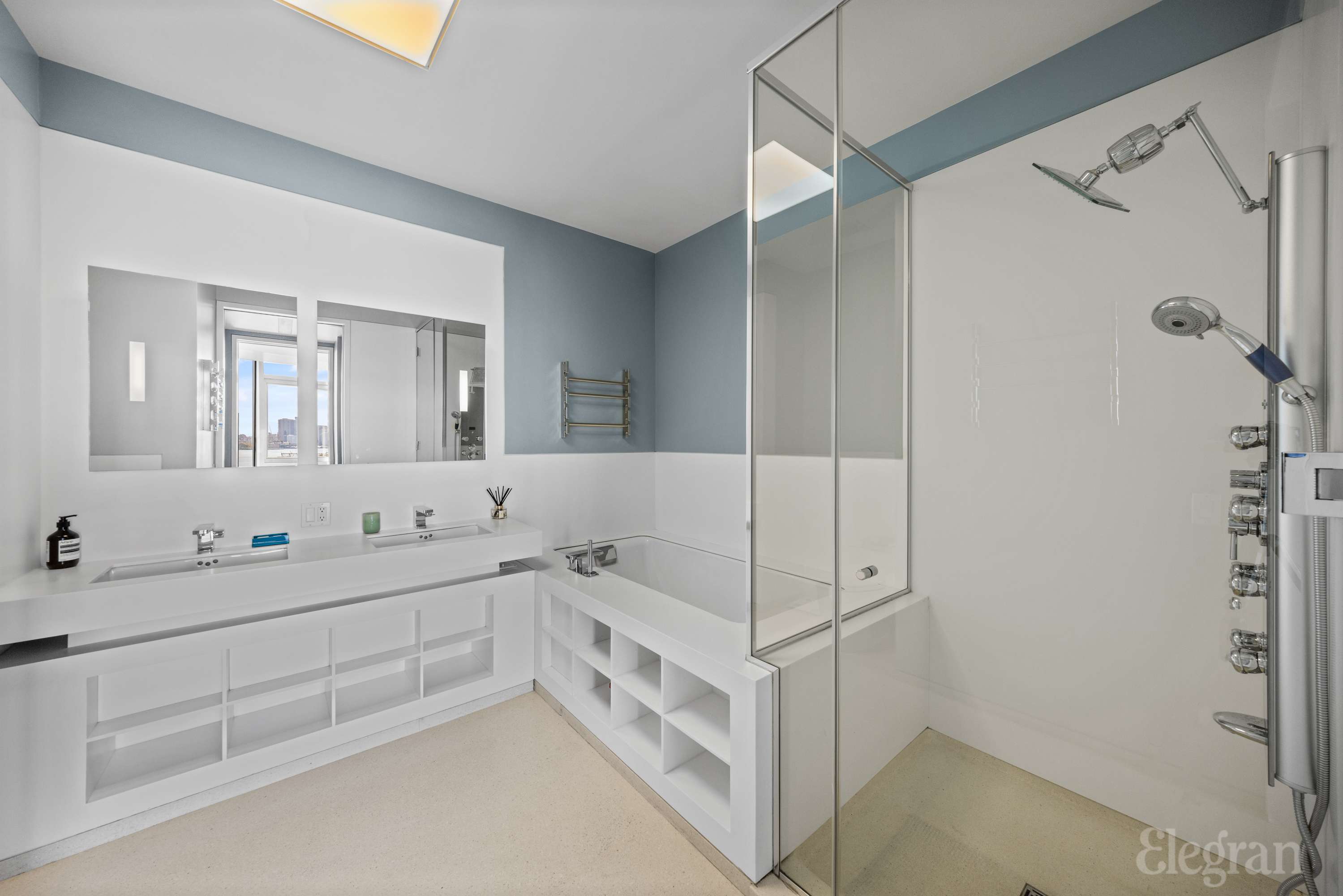 100 11th Avenue, Unit 11B Manhattan, NY 10011 - Photo 9 of 19 a bathroom with a double vanity sink mirror and bathtub