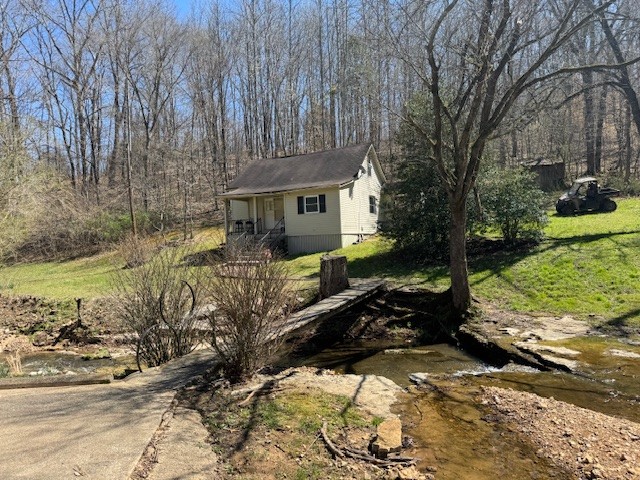 a view of a house with a yard covered in snow