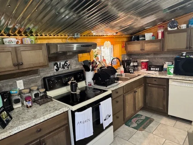 a kitchen with sink cabinets and appliances