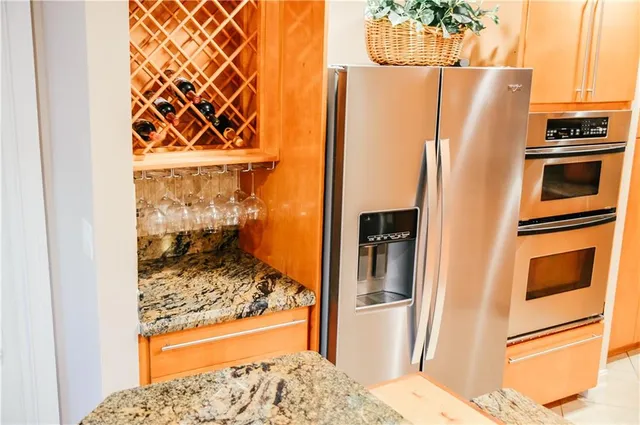 a bathroom with a refrigerator and window