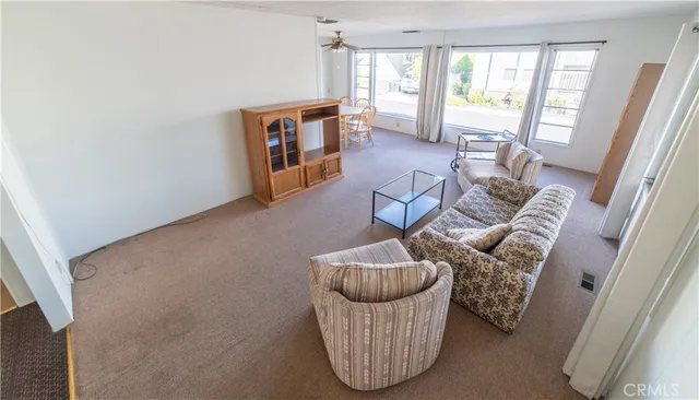 a living room with furniture and a floor to ceiling window