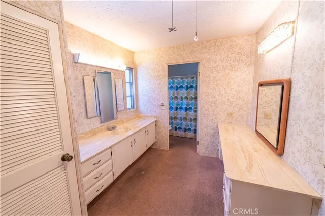 a large bathroom with a tub sink and mirror