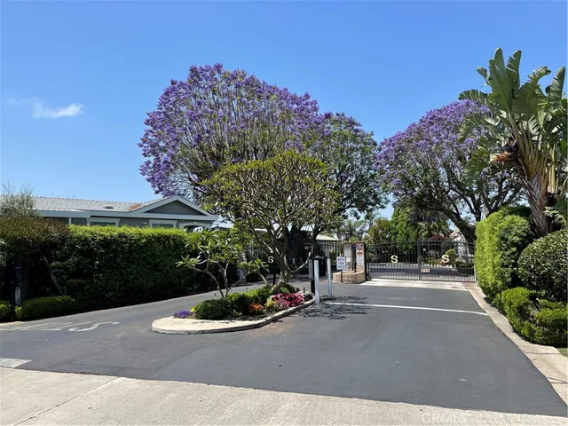 a view of a street with a house in the background