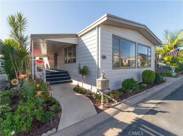 a front view of house with yard and outdoor seating