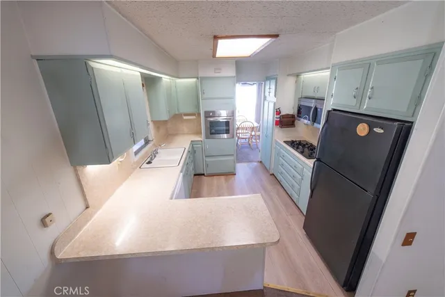 a view of kitchen with furniture and wooden floor
