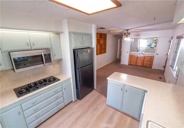 a kitchen with stainless steel appliances a refrigerator a stove a sink and a refrigerator