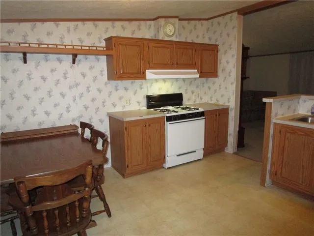 a kitchen with a cabinets and a stove top oven