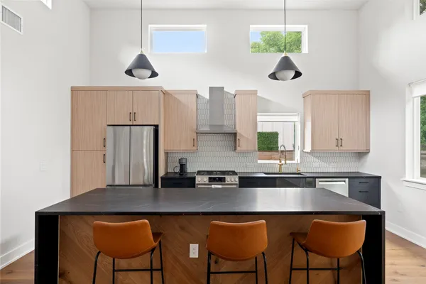 a kitchen with a table chairs stove and cabinets
