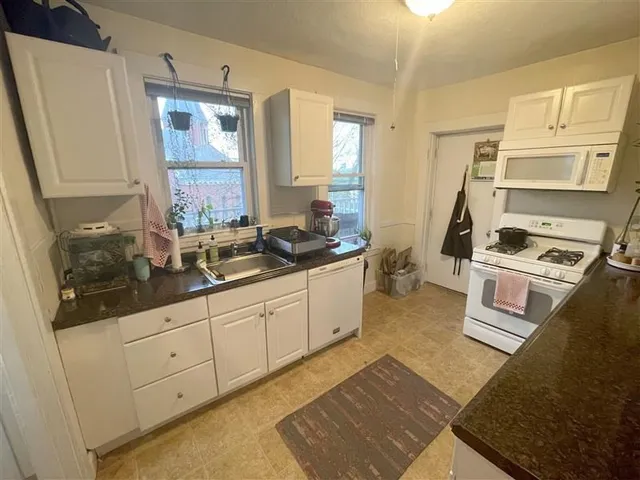 a kitchen with sink and cabinets