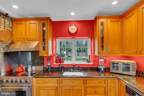 a dining room with furniture a chandelier and window