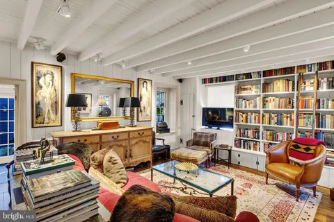 a living room with fireplace furniture and a wooden floor
