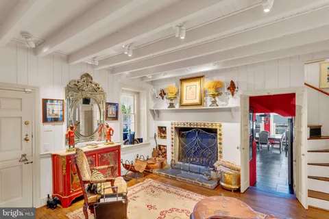a living room filled with furniture windows and a flat screen tv
