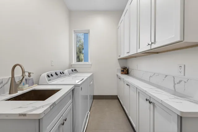 a kitchen with stainless steel appliances granite countertop a sink and dishwasher a stove with white countertops