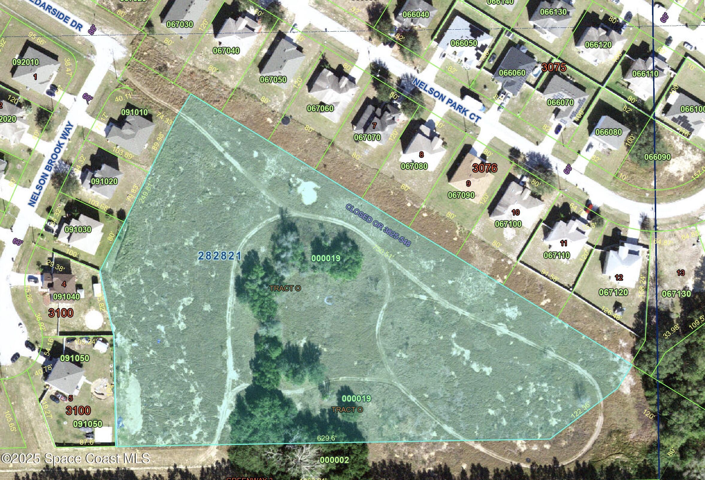 an aerial view of a residential houses with yard