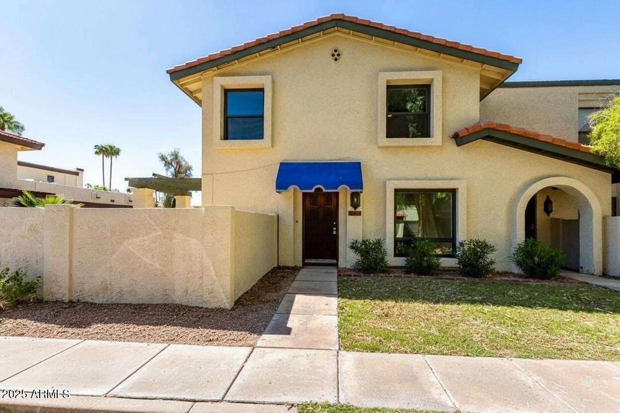 8635 South 48th Street, Unit 3 Phoenix, AZ 85044 - Photo 1 of 24 a front view of a house with garden