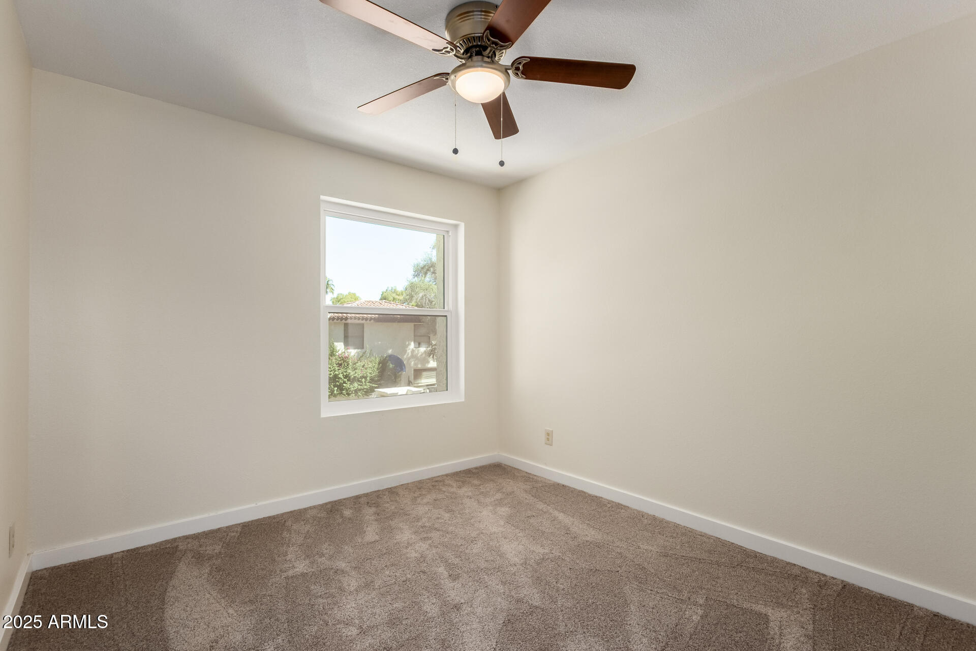 8635 South 48th Street, Unit 3 Phoenix, AZ 85044 - Photo 11 of 24 an empty room with a window and a fan