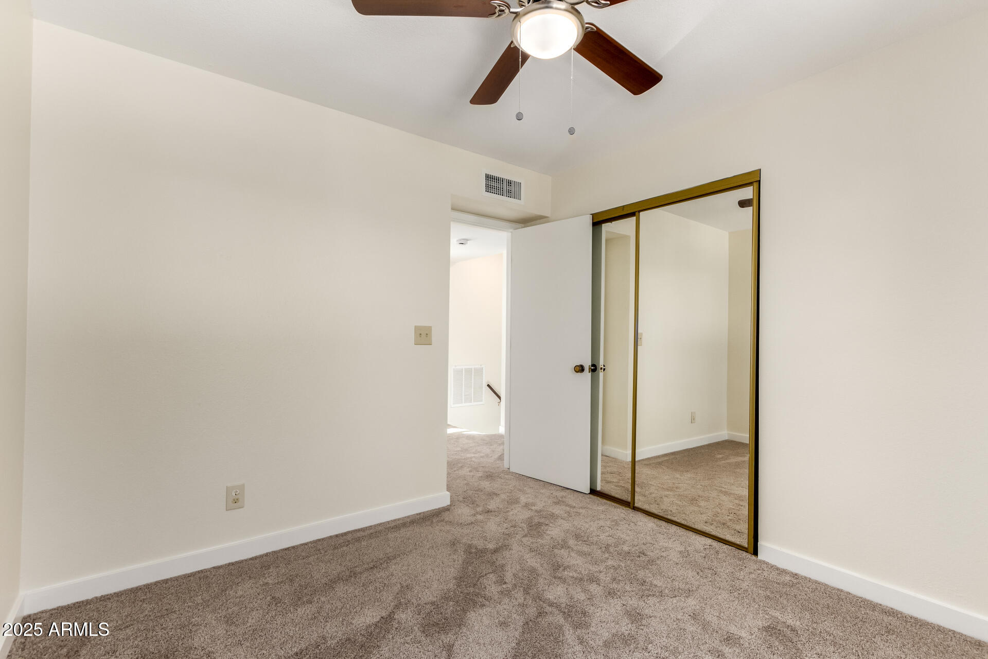 8635 South 48th Street, Unit 3 Phoenix, AZ 85044 - Photo 12 of 24 an empty room with a empty space and chandelier fan