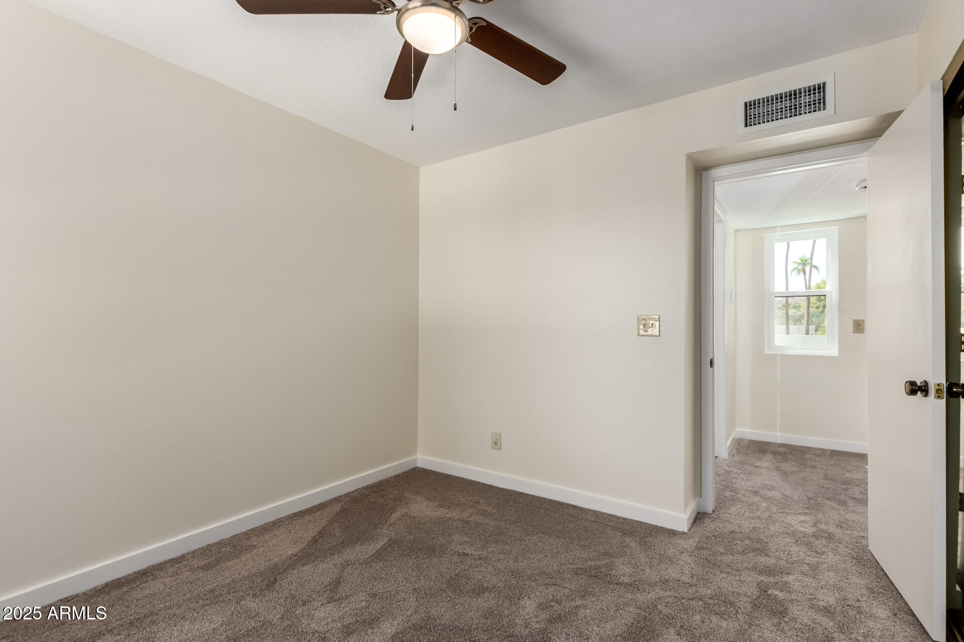 8635 South 48th Street, Unit 3 Phoenix, AZ 85044 - Photo 13 of 24 an empty room with a ceiling fan and a window