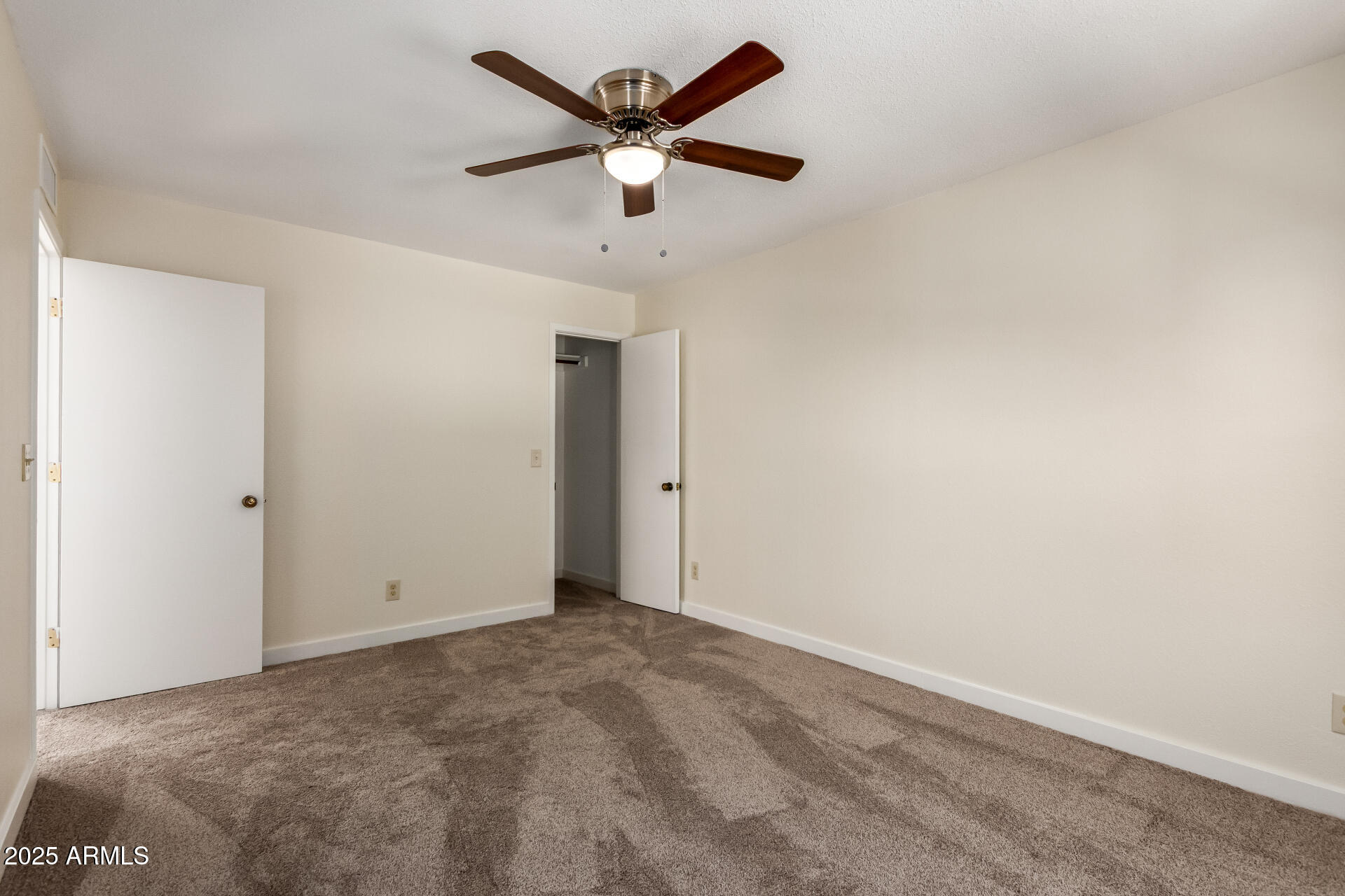 8635 South 48th Street, Unit 3 Phoenix, AZ 85044 - Photo 15 of 24 an empty room with a ceiling fan and a window